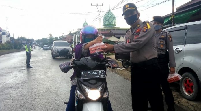 Polres Kubar Bagikan Takjil Bagi Pengendara Roda 2 saat Melintas di Depan Makopolres